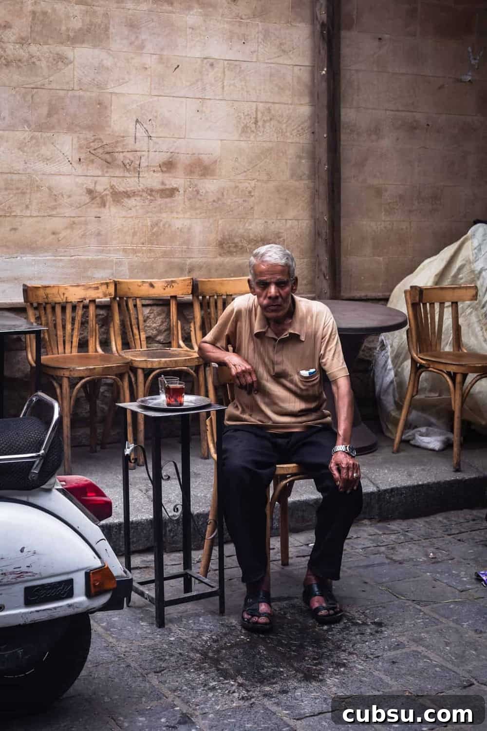 Cairo Adventures: Top Experiences and Hidden Gems to Explore 12 portrait shot of an old man sitting in a cafe in Old Cairo, posing for my camera.