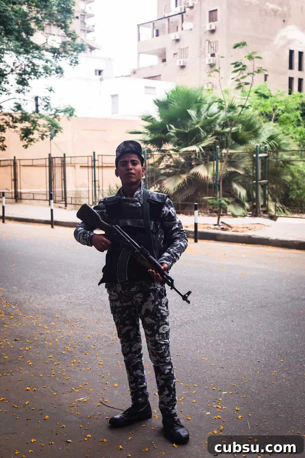 Cairo Adventures: Top Experiences and Hidden Gems to Explore 16 Portrait shot of a security guard proudly posing with his gun in the Zamalek district of Old Cairo.