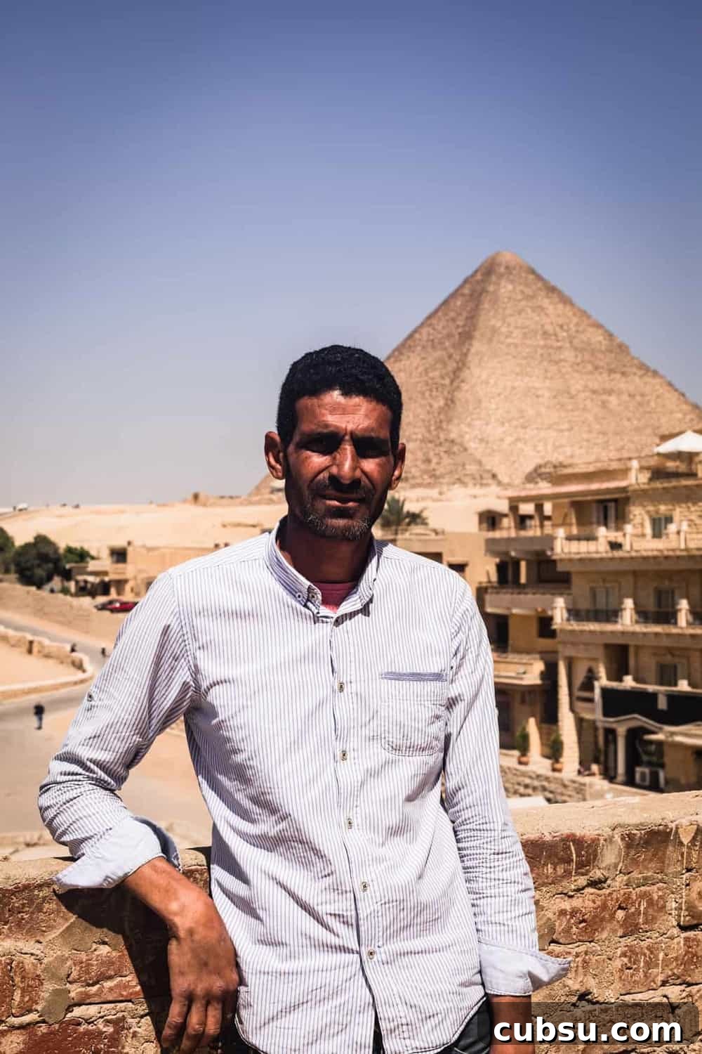 Cairo Adventures: Top Experiences and Hidden Gems to Explore 18 Portrait shot of my Giza tour guide, in front of the Great Pyramids.