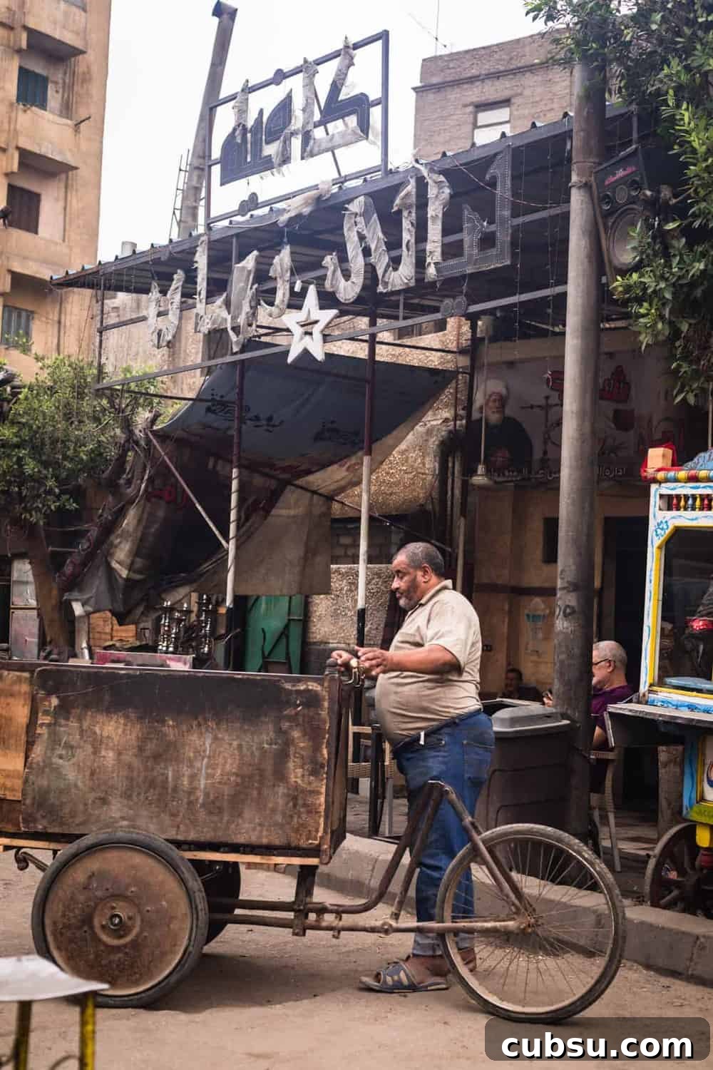 Cairo Adventures: Top Experiences and Hidden Gems to Explore 4 Man with a bicycle cart contraption right outside the gates of Old Cairo.