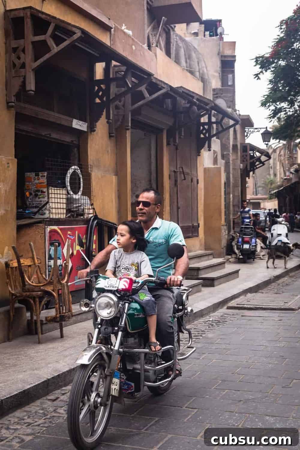 Cairo Adventures: Top Experiences and Hidden Gems to Explore 6 Father and son riding an moped in Old Cairo.