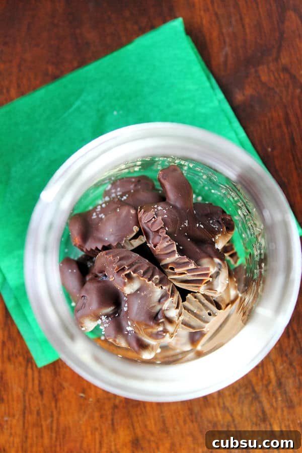 Cherry Almond Clusters: No-Bake Chocolate Snack Bites 4 an overhead shot of a jar full of Cherry Almond Clusters sitting on a green napkin