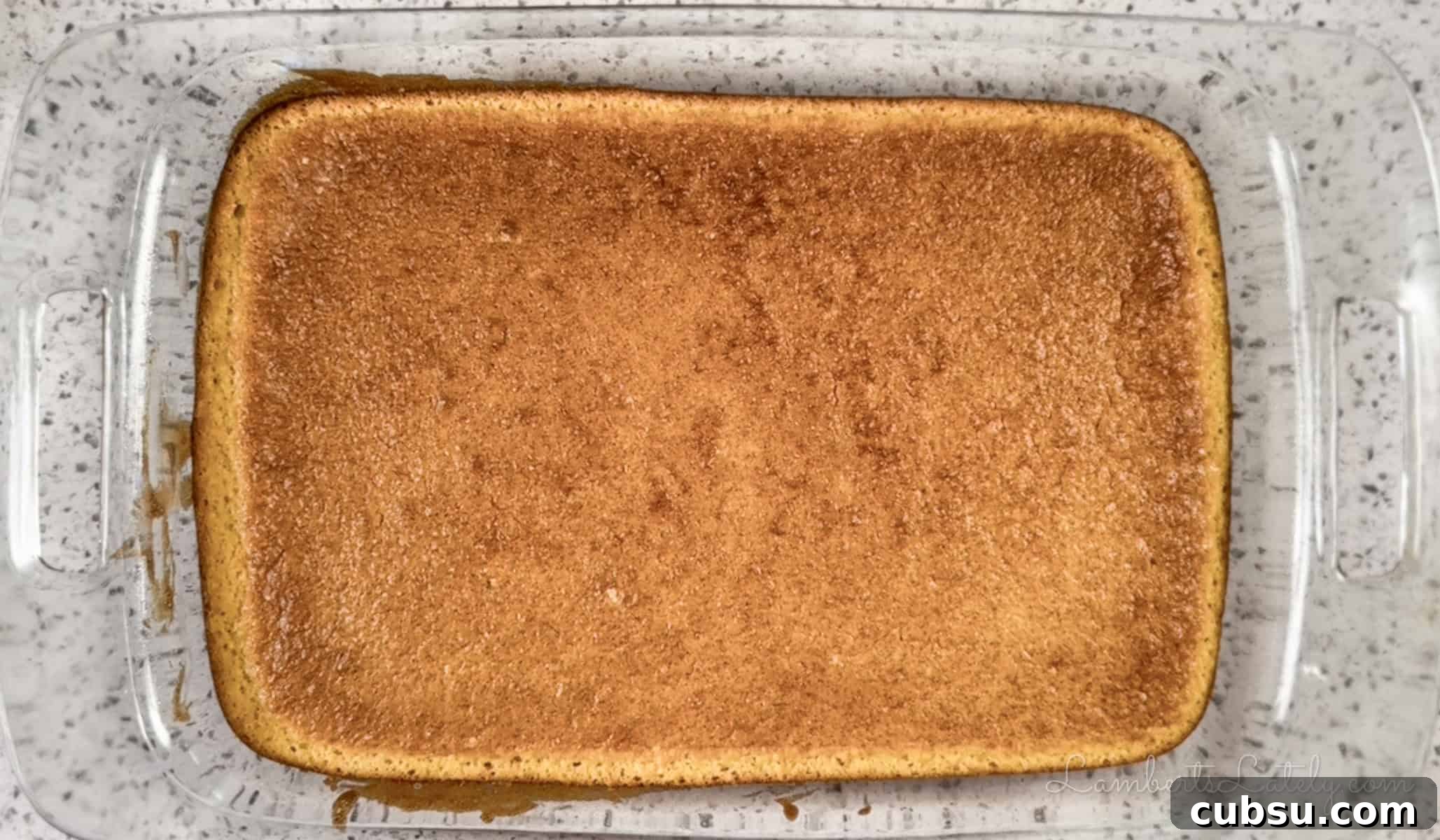 baked yellow sheet cake in a glass dish.