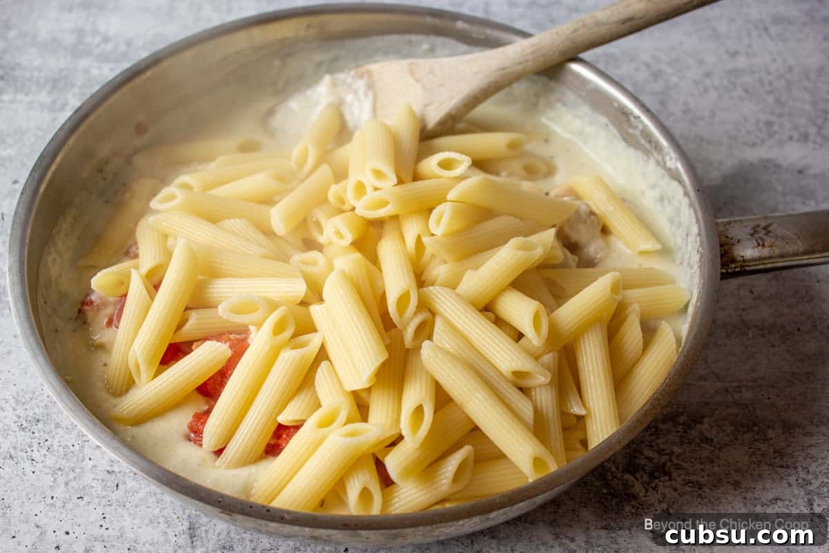 Penne pasta in a saute pan.