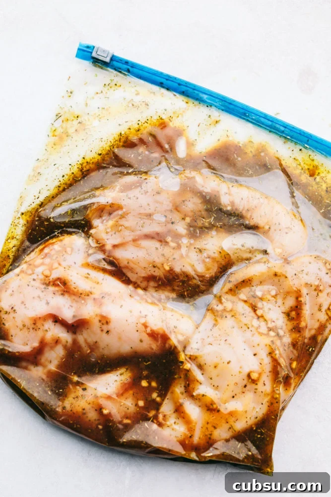 Chicken marinating in a ziploc bag.