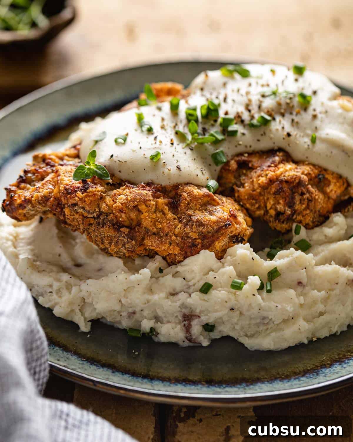 Air fryer chicken fried steak on a blue plate.