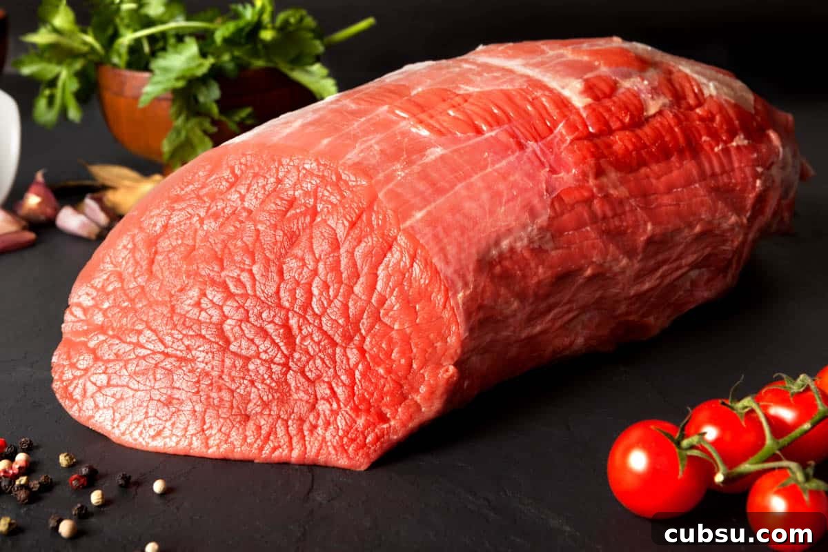 Top Cuts for Homemade Beef Jerky (+Video) 4 beef Eye of round on dark cutting board, the best meat for beef jerky