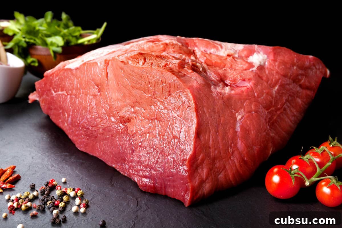 Top Cuts for Homemade Beef Jerky (+Video) 6 Beef Top Round on cutting board with tomatoes, the second best meat for beef jerky