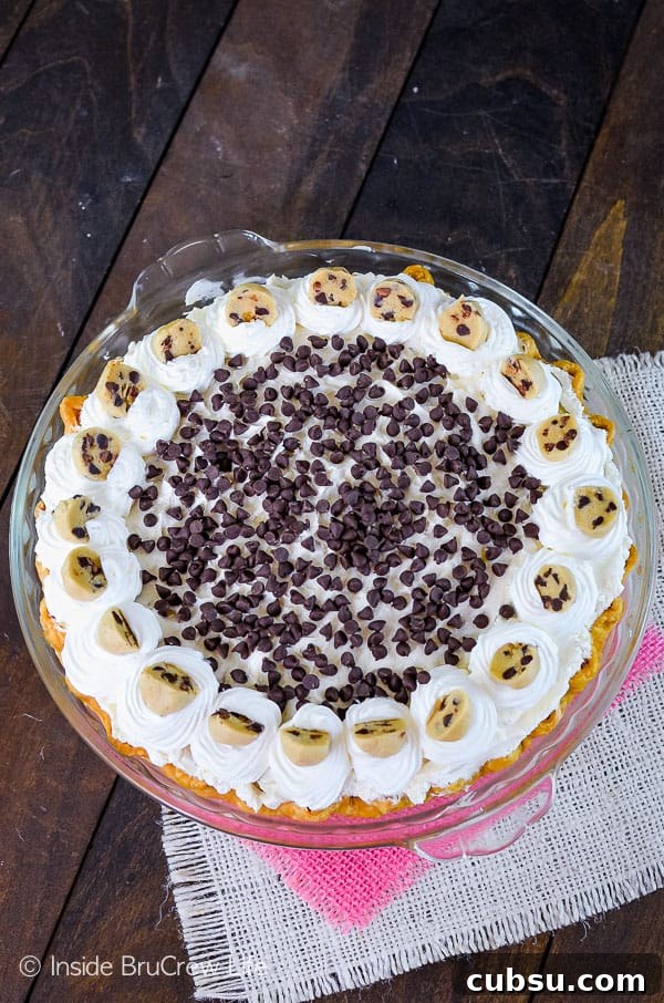 Cookie Dough Cheesecake Brownie Pie Cookie Dough Cheesecake Brownie Pie - mini chocolate chips and cookie dough bites add a fun flair to this fudgy brownie pie!