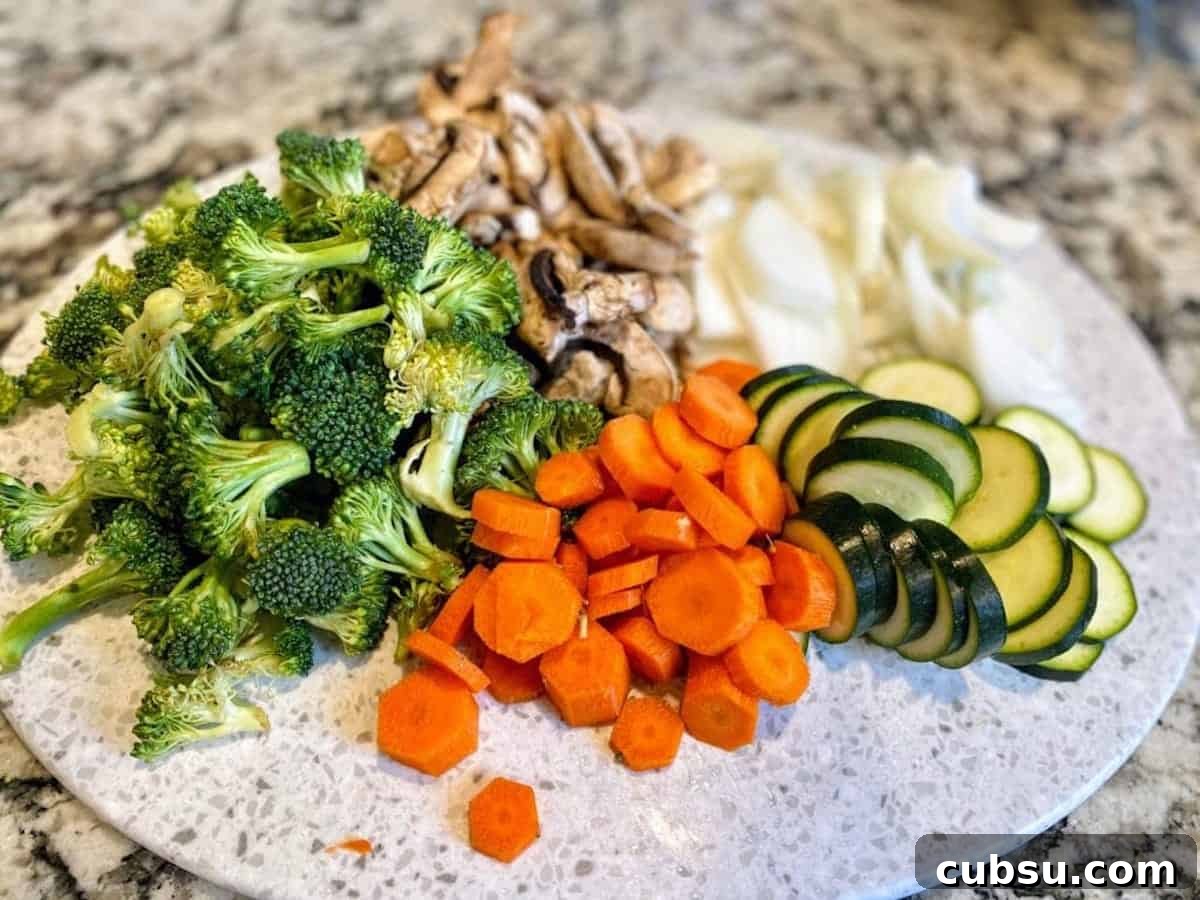 Vegan Pesto Pasta Recipe with Creamy Cashew Sauce 2 Cut broccoli, mushrooms, white onions, zucchini and carrots.