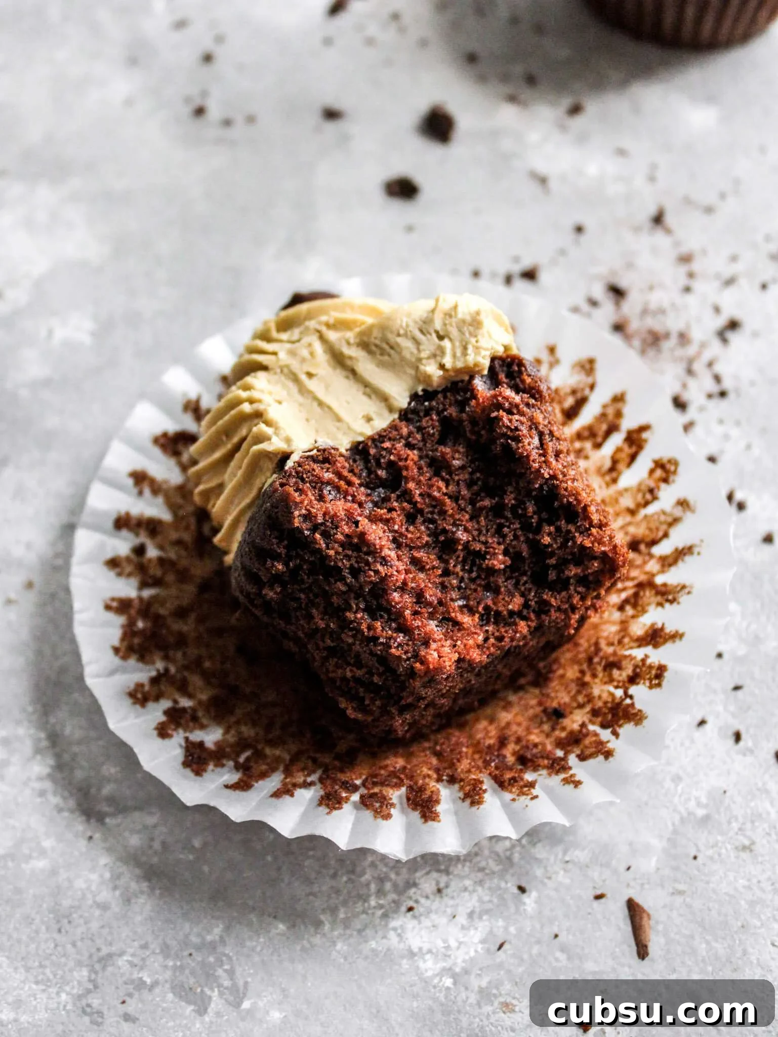 Muffins vs Cupcakes: Key Differences, Taste & Baking Tips 5 chocolate espresso cupcakes on table with bite missing (2)