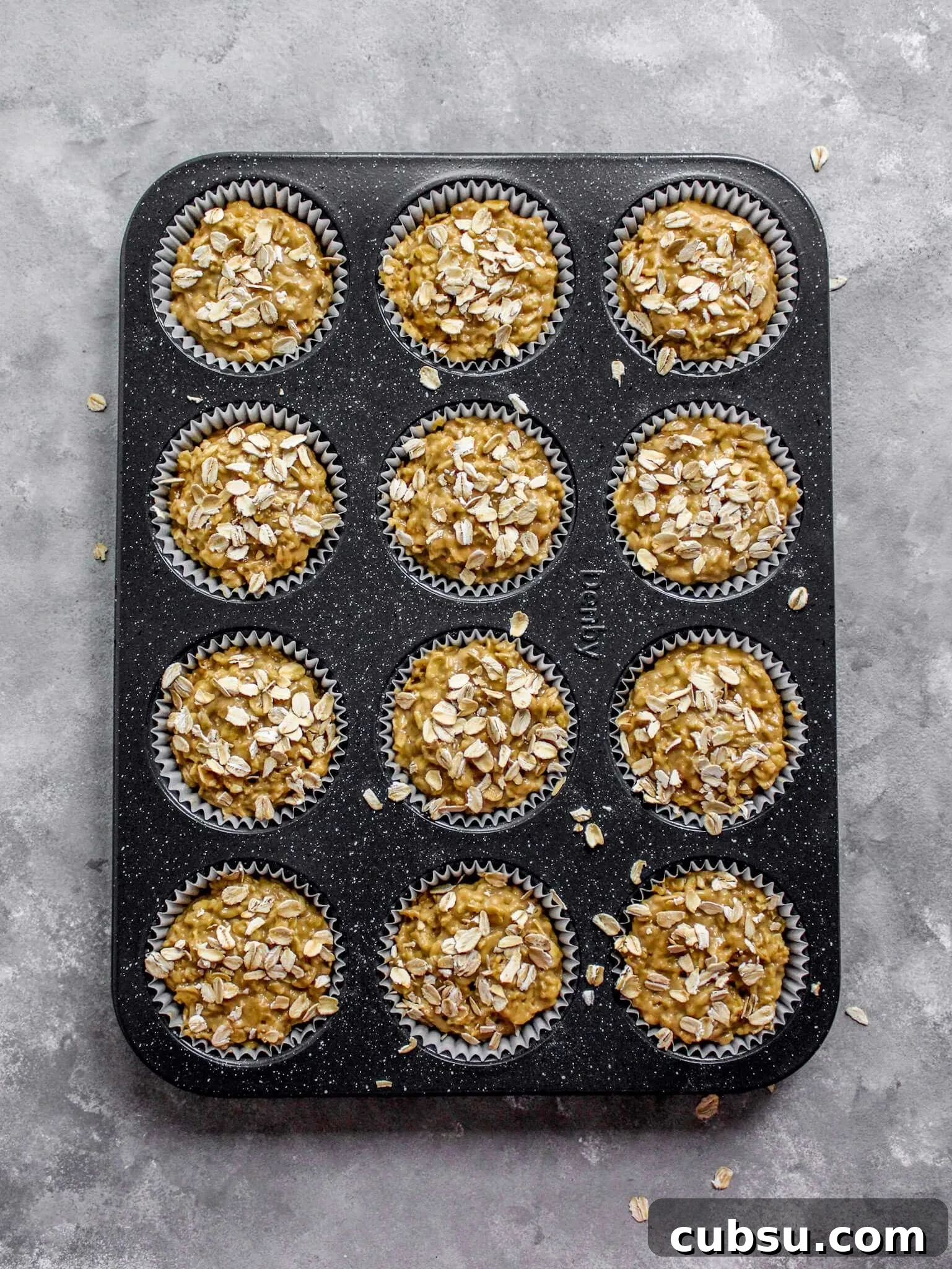Muffins vs Cupcakes: Key Differences, Taste & Baking Tips 10 oatmeal muffin batter in muffin pan