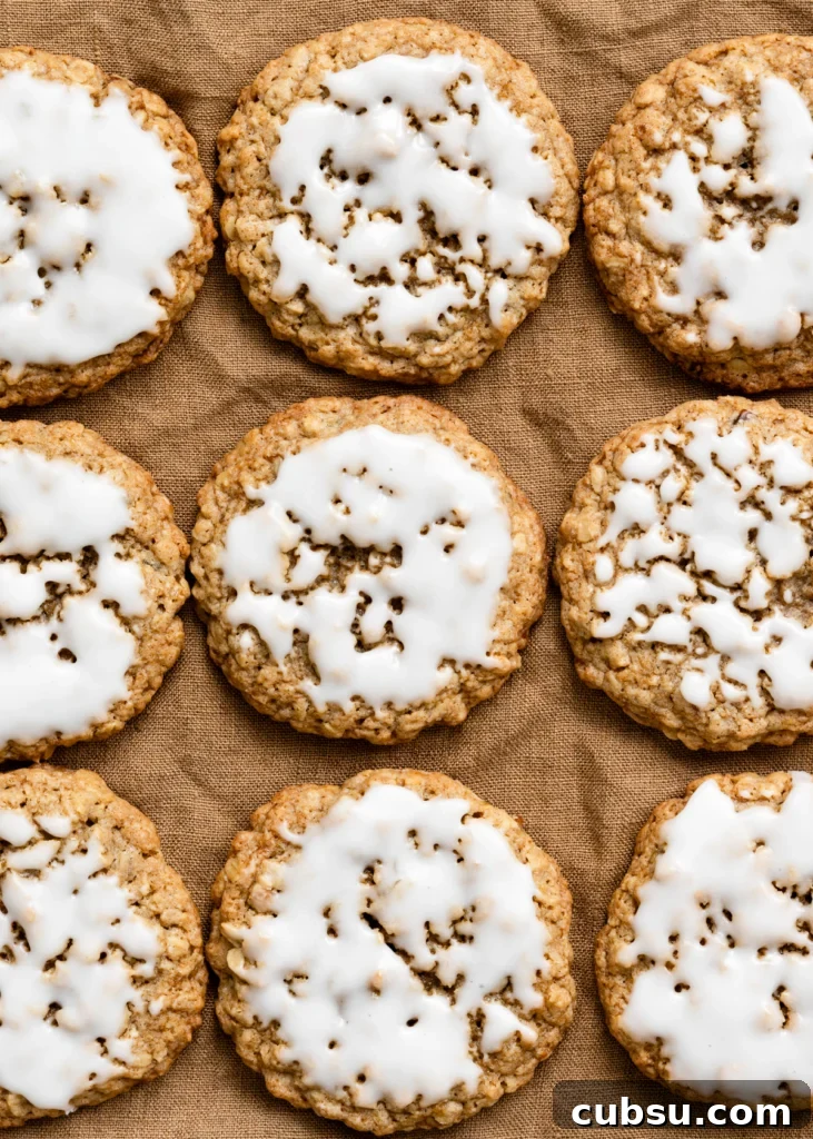 Zesty Lemon Oatmeal Cookies with a Refreshing Iced Glaze 2 Overhead view of iced oatmeal cookies in rows on a linen cloth.
