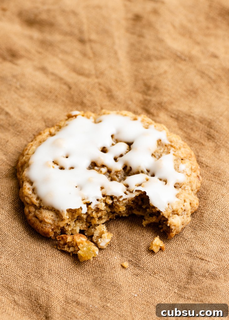 Zesty Lemon Oatmeal Cookies with a Refreshing Iced Glaze 8 Closeup of an iced oatmeal cookie with a bite missing out of the side.