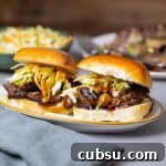 Two braised beef sliders topped with citrus slaw.