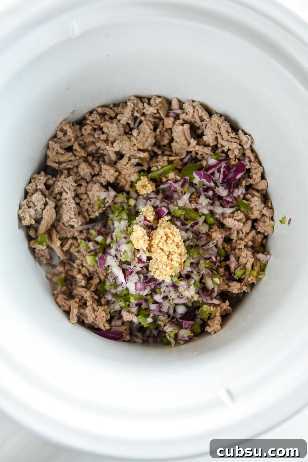 cooked ground turkey, chopped jalapeños and onions and minced garlic in slow cooker