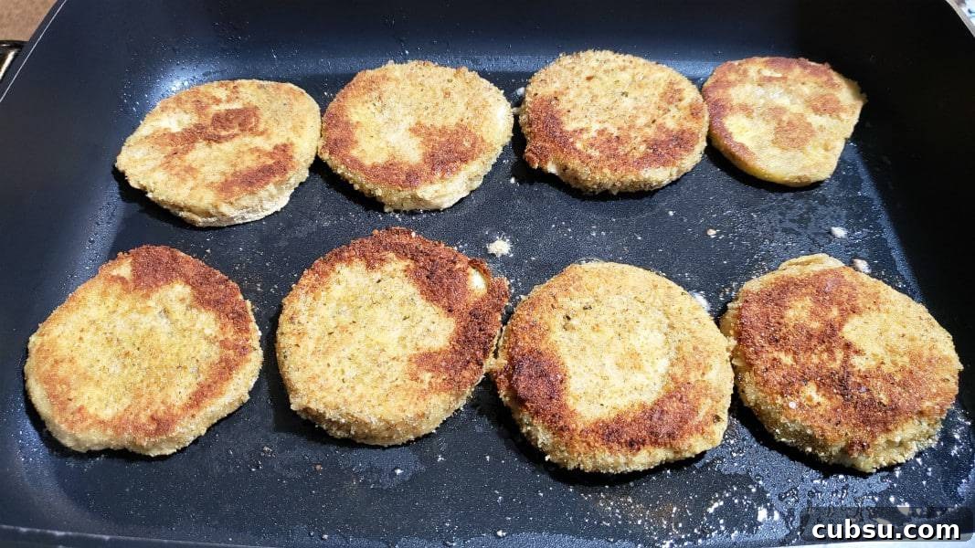 Crispy Oven-Baked Eggplant Parmesan Recipe 7 8 breaded eggplant slices frying in a skillet