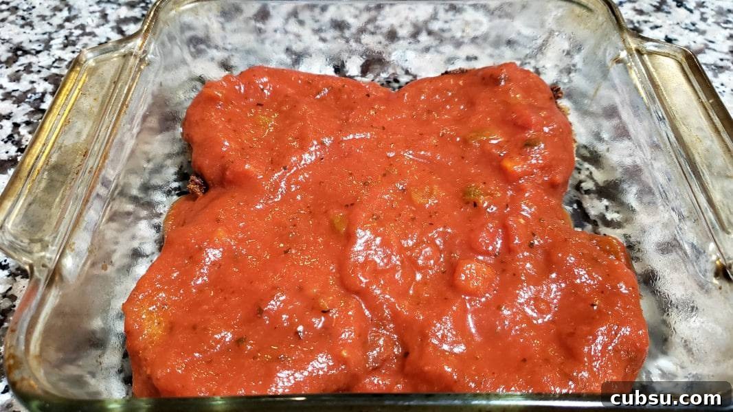 Crispy Oven-Baked Eggplant Parmesan Recipe 9 spaghetti sauce on top of eggplant slices