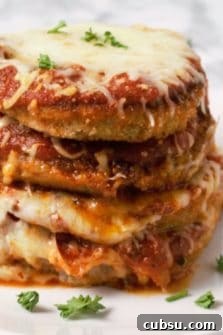 Crispy Oven-Baked Eggplant Parmesan Recipe 12 a stack of Eggplant Parmesan on a plate.