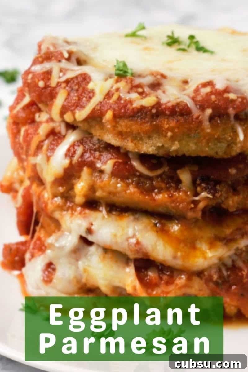 Crispy Oven-Baked Eggplant Parmesan Recipe 14 a stack of 4 Breaded Baked Eggplant Parmesan on a plate.