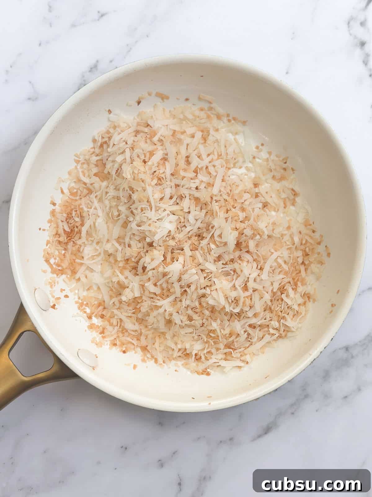 Zesty Lime Coconut Cookies Recipe for Fresh Tropical Flavor 5 toasted coconut in a frying pan.