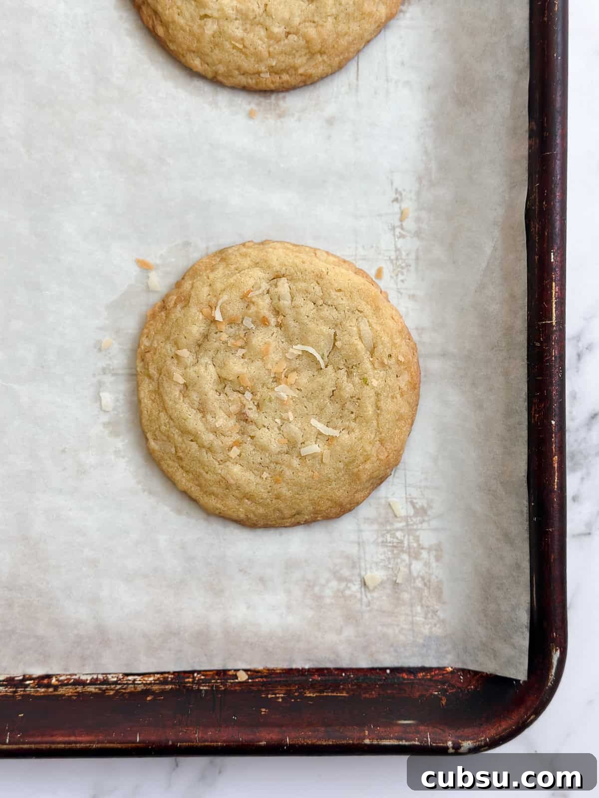 Zesty Lime Coconut Cookies Recipe for Fresh Tropical Flavor 10 freshly bakes lime coconut cookies on the baking sheet.