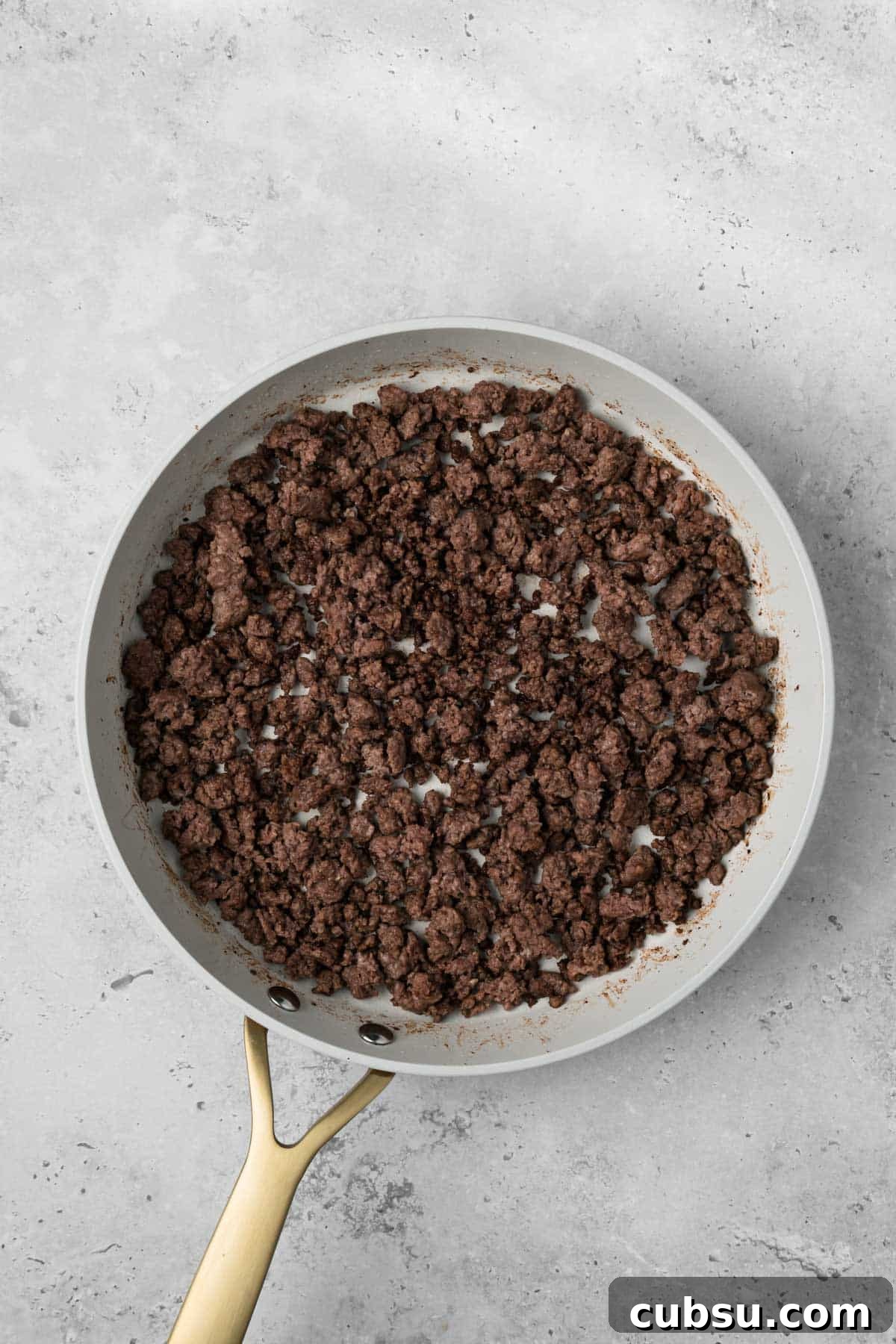 Make-Ahead Breakfast Burritos for Busy Mornings 5 overhead view of cooked ground meat for breakfast burritos in a skillet.