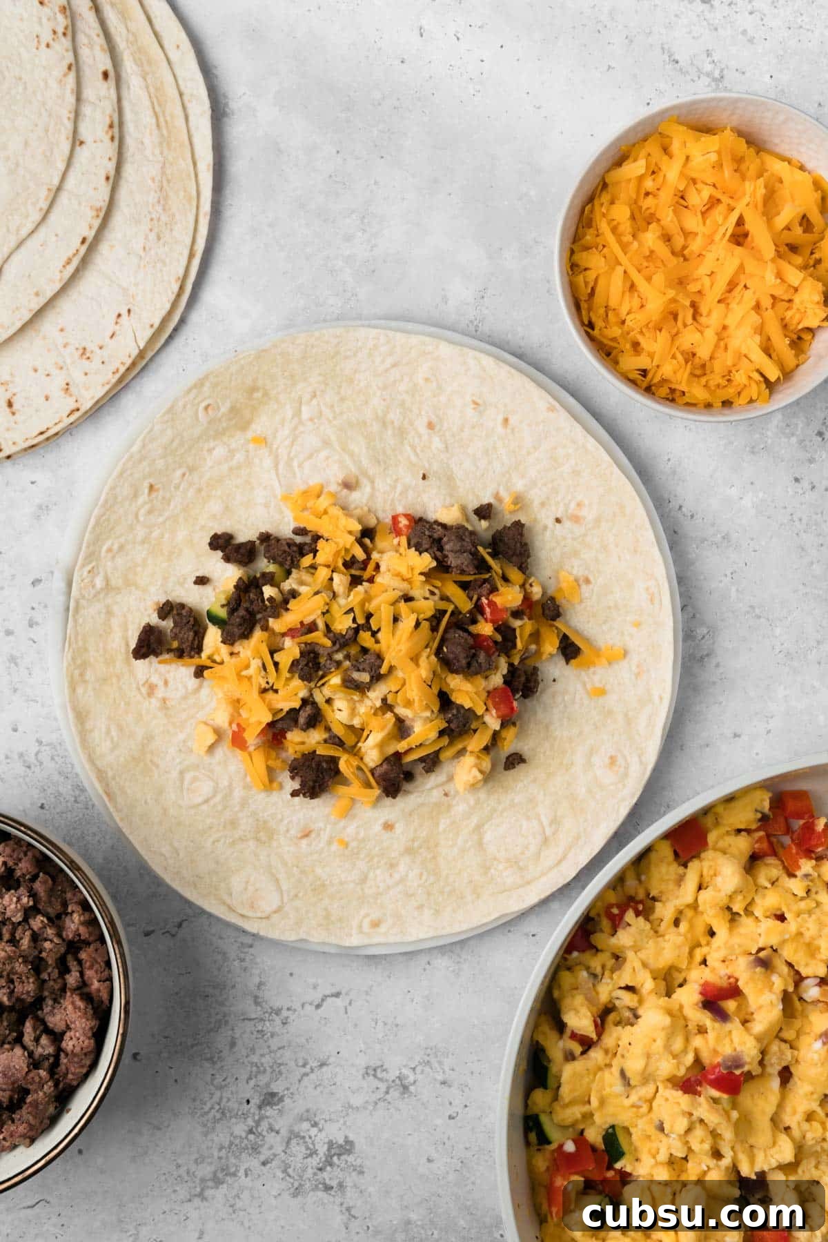 Make-Ahead Breakfast Burritos for Busy Mornings 8 overhead view of a breakfast burrito being assembled.