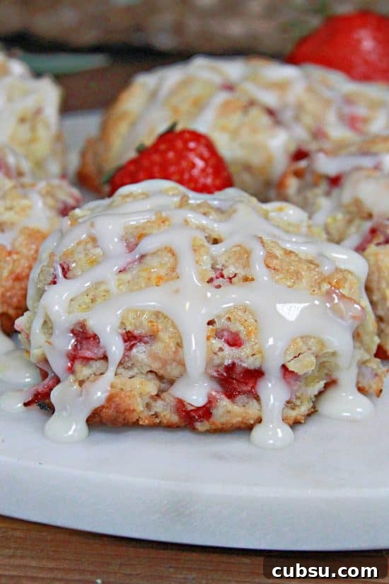 Flaky Strawberry Scones Recipe for Homemade Brunch 3 A citrus glaze drizzled over a buttery, flaky scone made with fresh strawberries.
