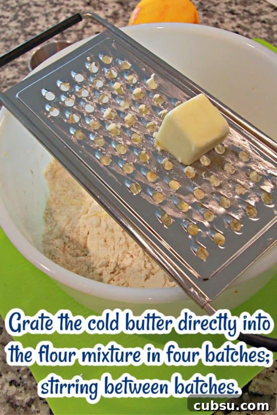 Flaky Strawberry Scones Recipe for Homemade Brunch 5 Grating cold butter into a dough for flaky, tender scones.