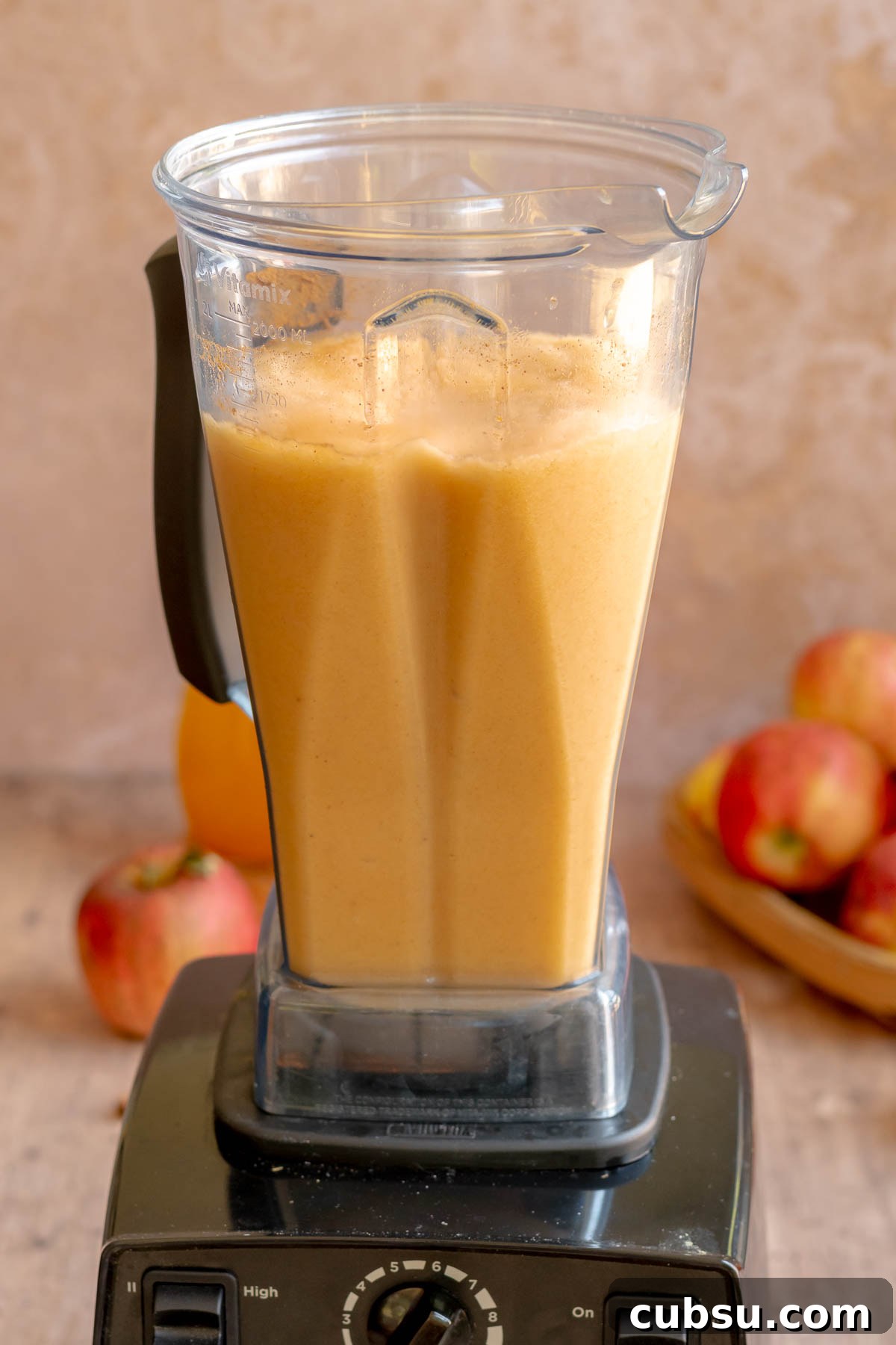Spiced Apple Cider Slushies — Boozy or Virgin Recipes for Fall 10 Blended apple cider slushie in a blender.