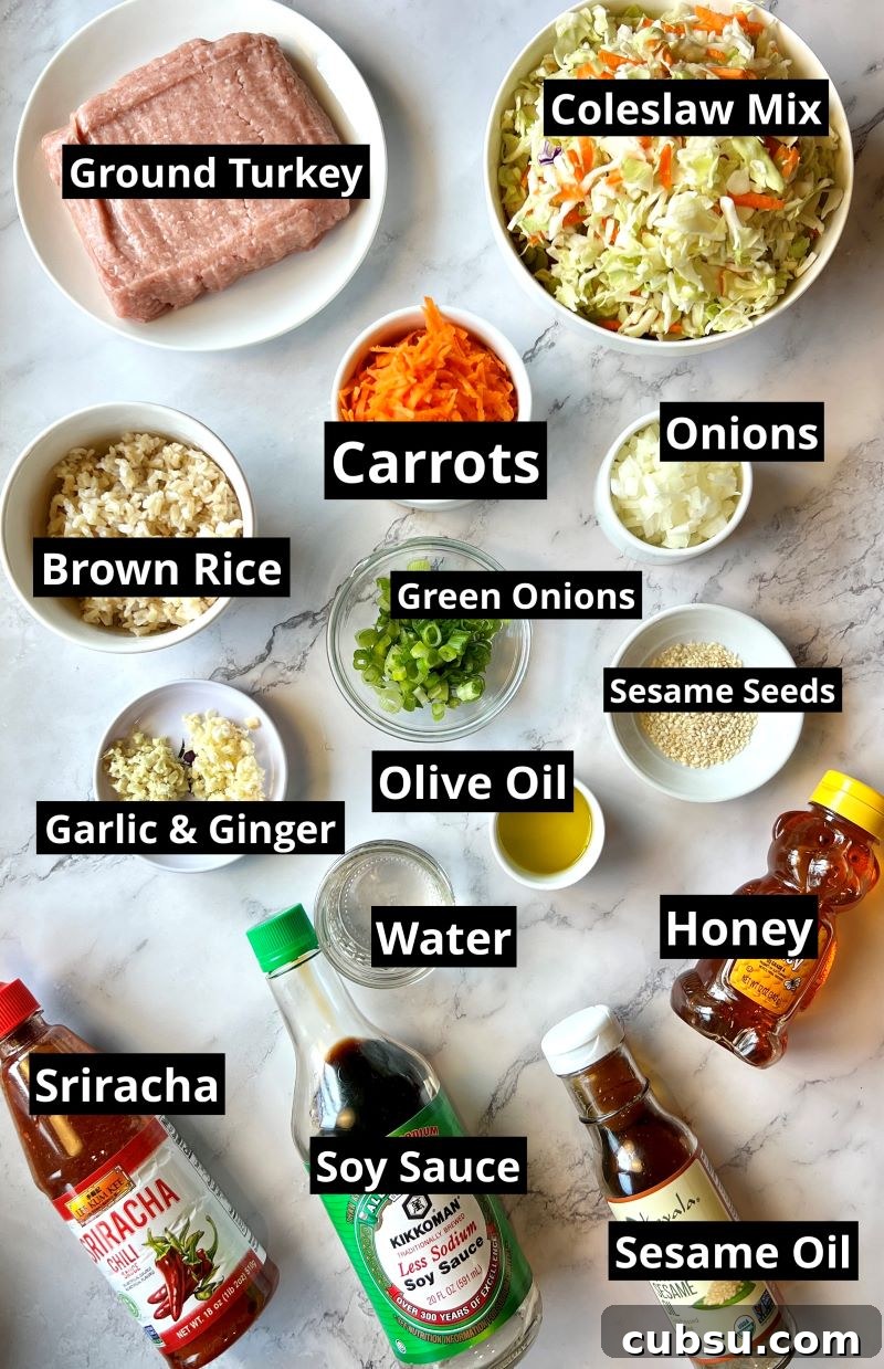Skillet Egg Roll Bowls with Ground Pork and Veggies 2 Ingredients list for one-pan egg roll bowls. ground turkey, onions, garlic, ginger, carrots, coleslaw mix, olive oil, brown rice, water, honey, sesame oil, soy sauce, siracha, and sesame seeds.