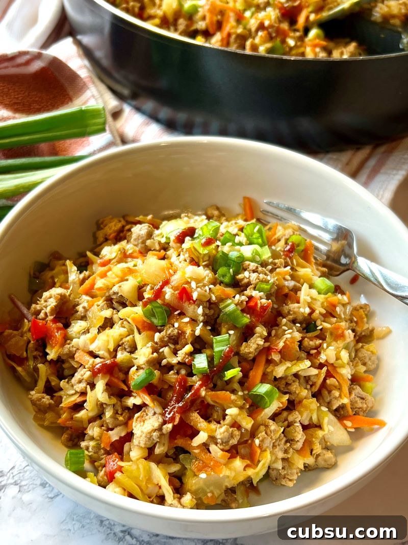 Skillet Egg Roll Bowls with Ground Pork and Veggies 8 One-pan egg roll bowls served in individual serving bowls with extra siracha hot sauce.