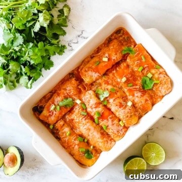 A baking dish full of chicken enchiladas.