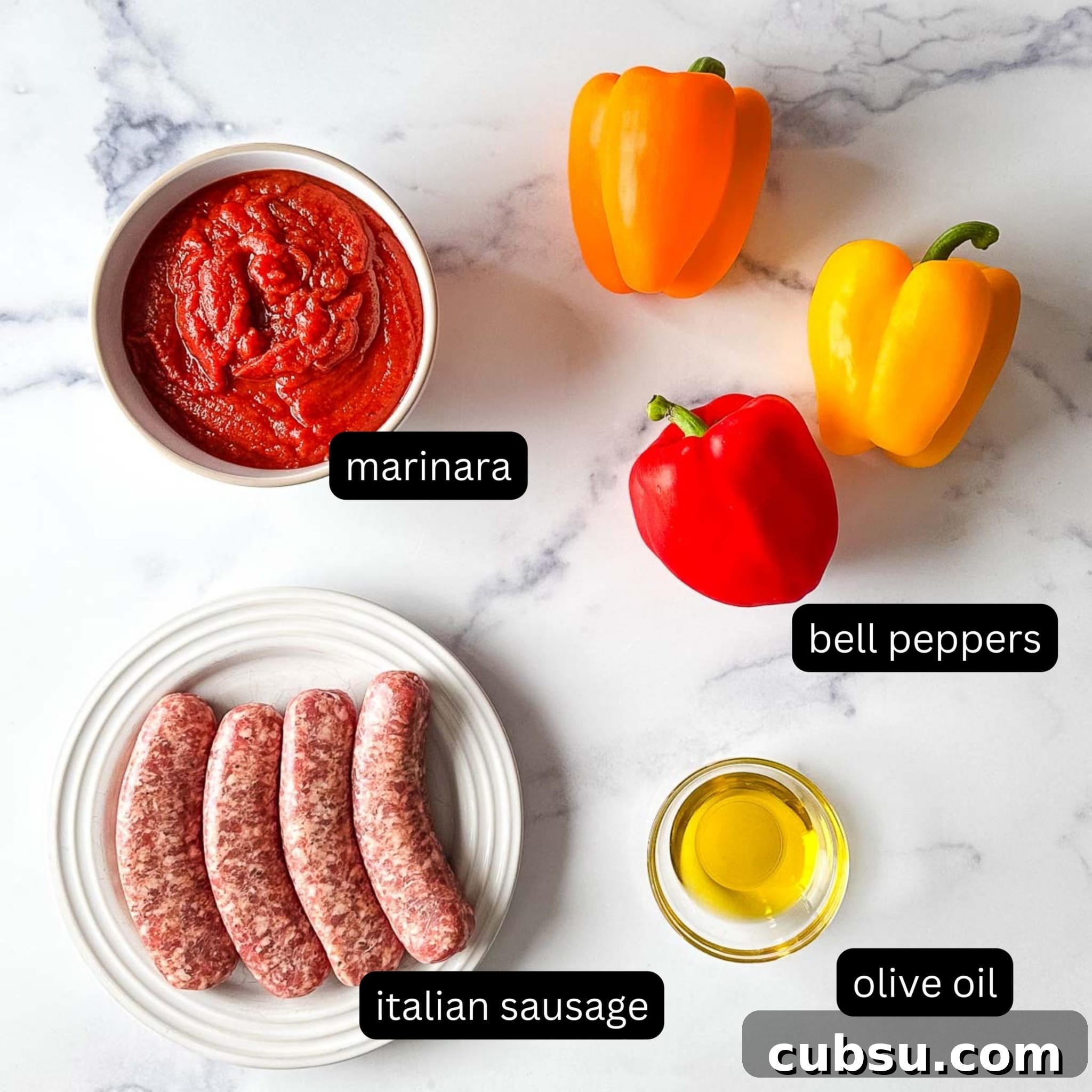 Ingredients for a slow cooker sausage and peppers recipe on a marble countertop.
