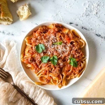 a plate of slow cooker lamb ragu over pappardelle pasta.