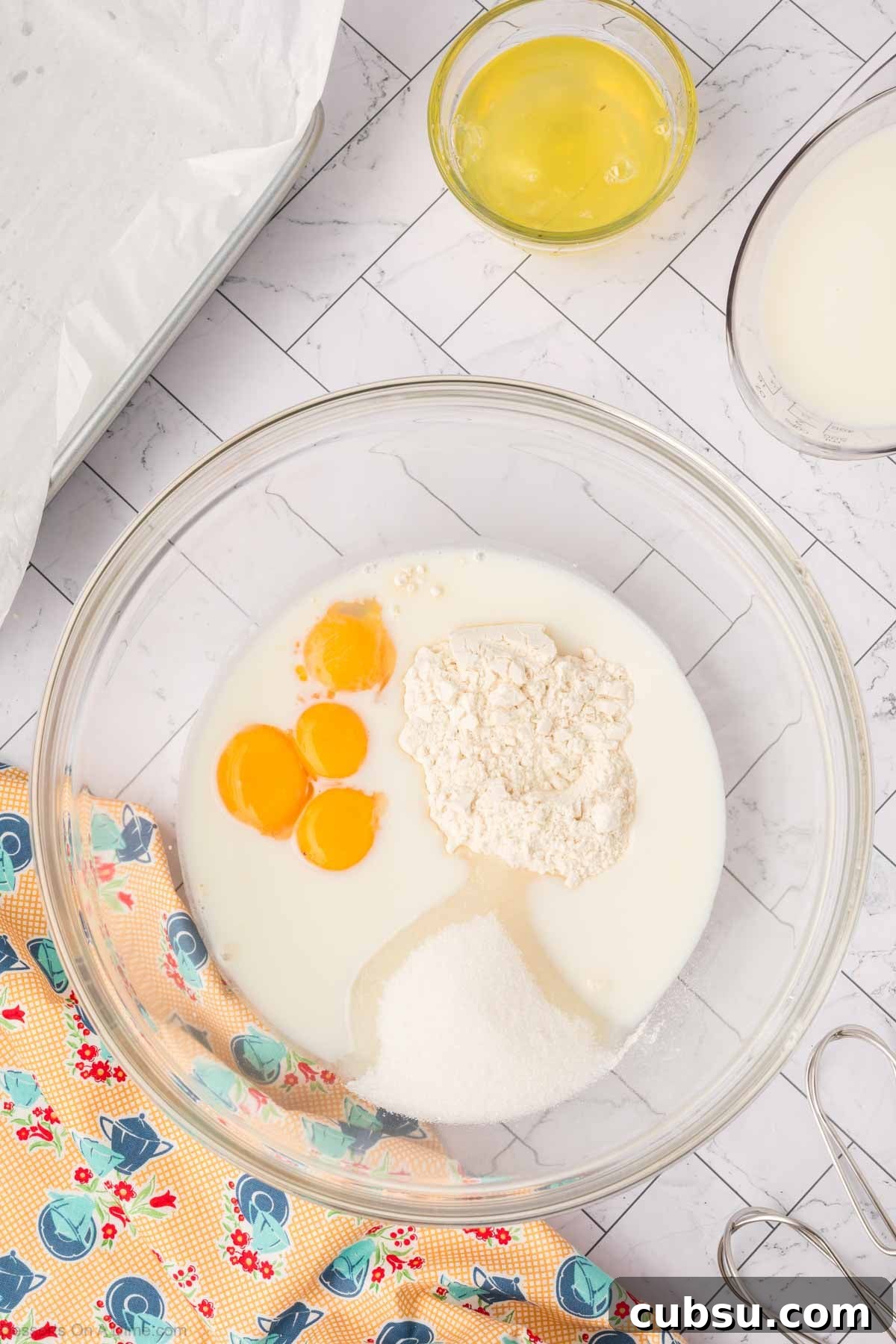Make-Ahead Magic Cake Recipe: Fluffy Three-Ingredient Sponge 5 Mixing bowl with eggs, flour, sugar and milk.