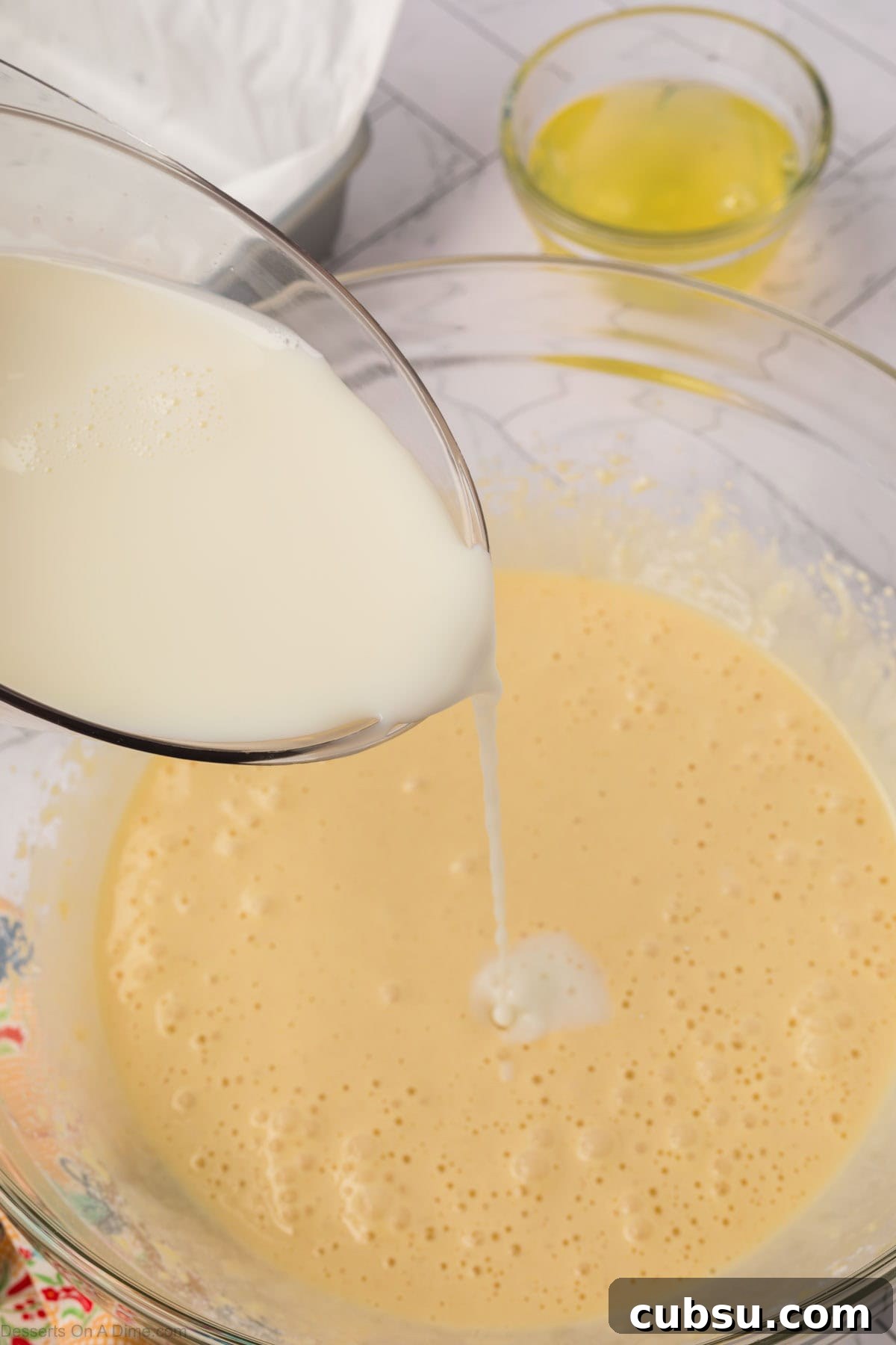 Make-Ahead Magic Cake Recipe: Fluffy Three-Ingredient Sponge 6 Milk poured into batter.
