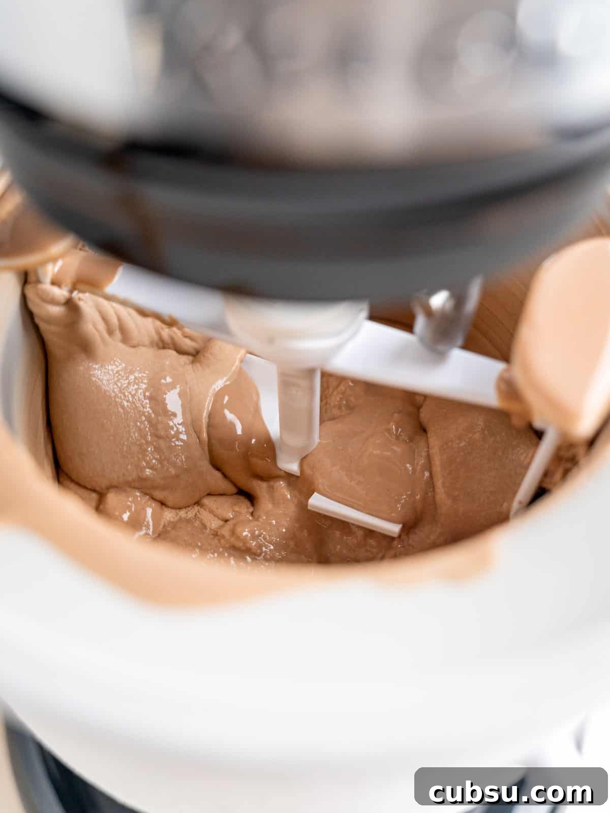 Churning chocolate malted ice cream in a Kitchenaid ice cream maker attachment.
