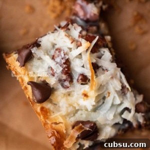7-Layer Magic Cookie Bars Recipe: Simple Crowd-Pleaser 14 Magic cookie bar on brown parchment paper