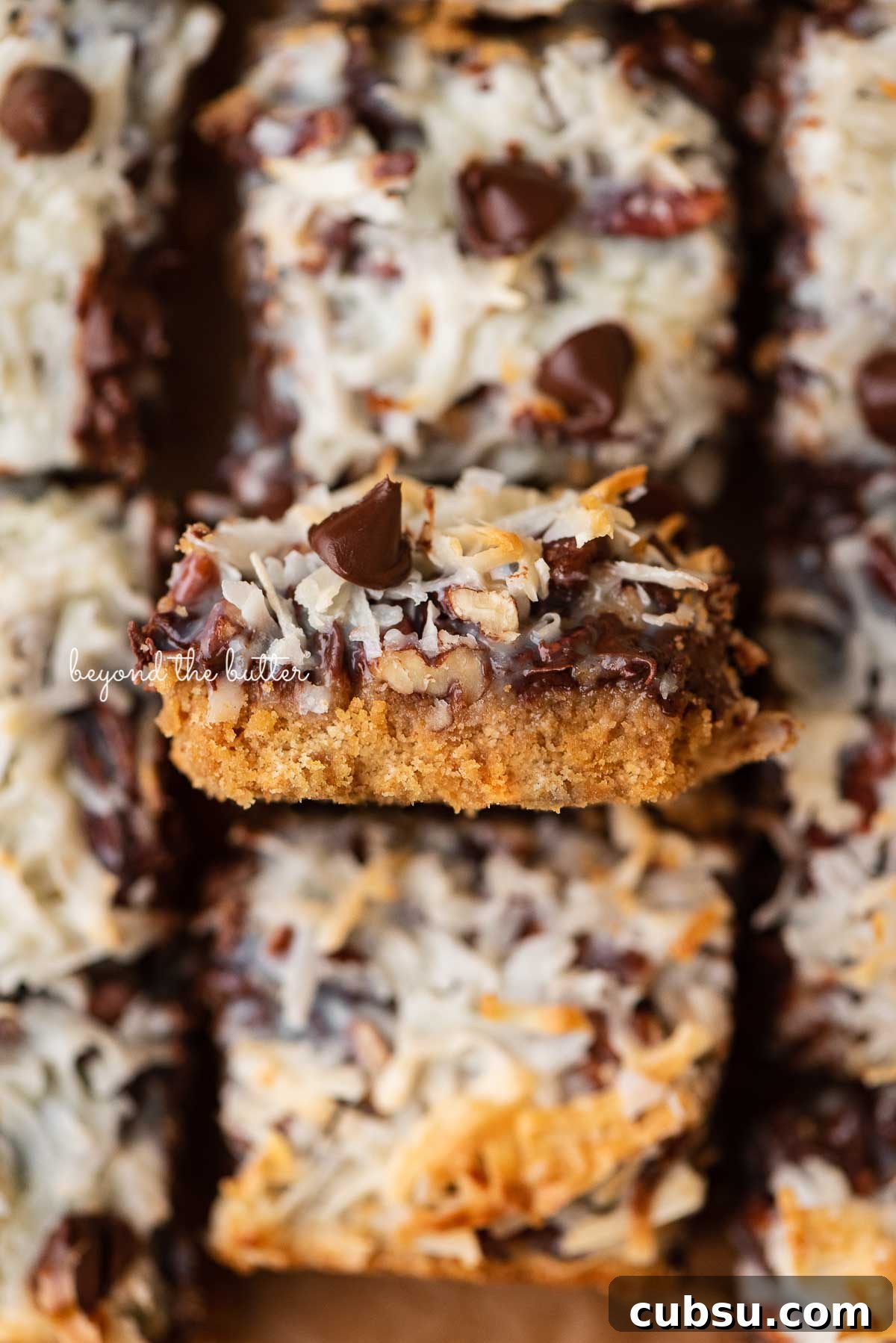 7-Layer Magic Cookie Bars Recipe: Simple Crowd-Pleaser 8 Sliced 7 layer magic cookie bars with center bar on its side