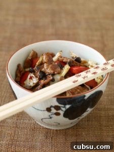 Spicy Chungking Pork in a bowl with chopsticks