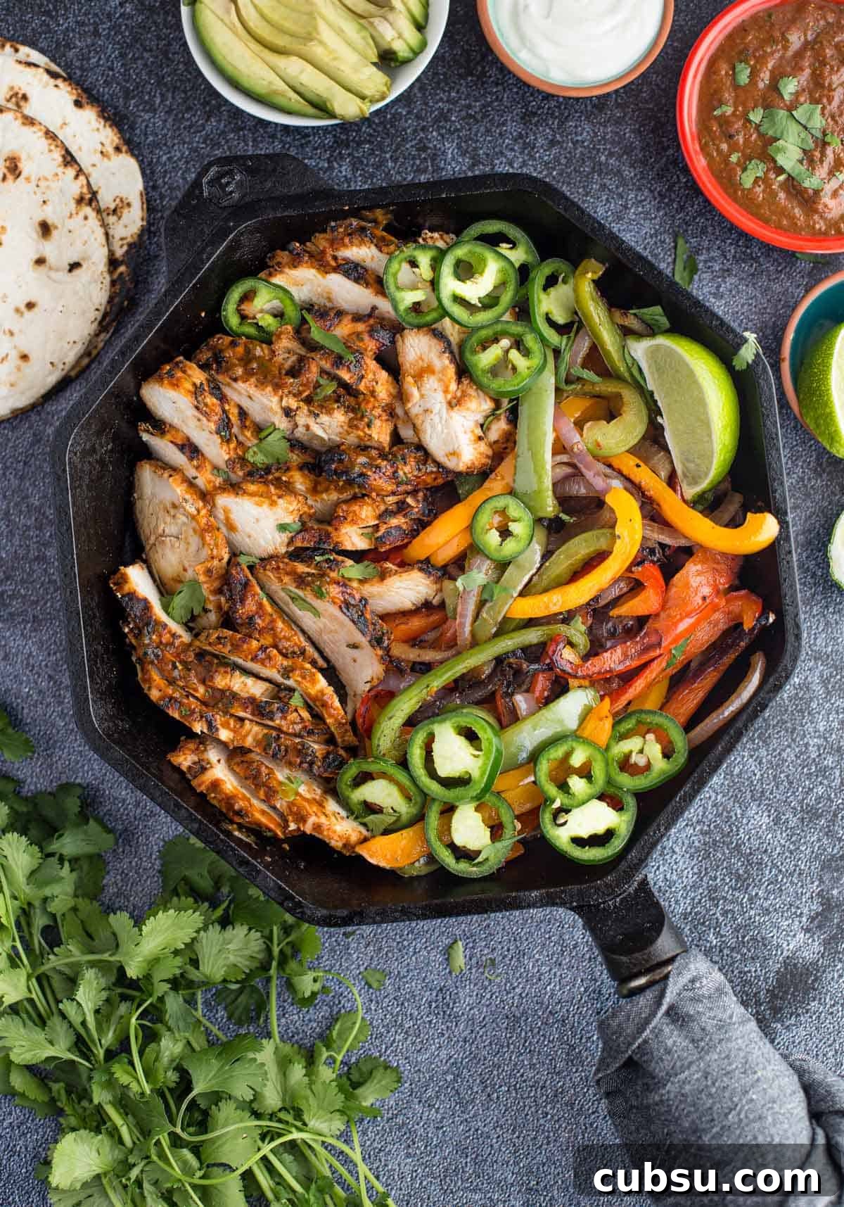 grilled chicken fajitas in a cast iron skillet