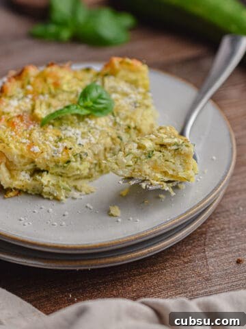 A piece of the zucchini casserole with bisquick is on a fork.