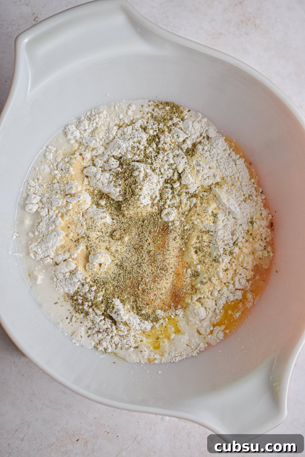 The seasonings are added to the large bowl.