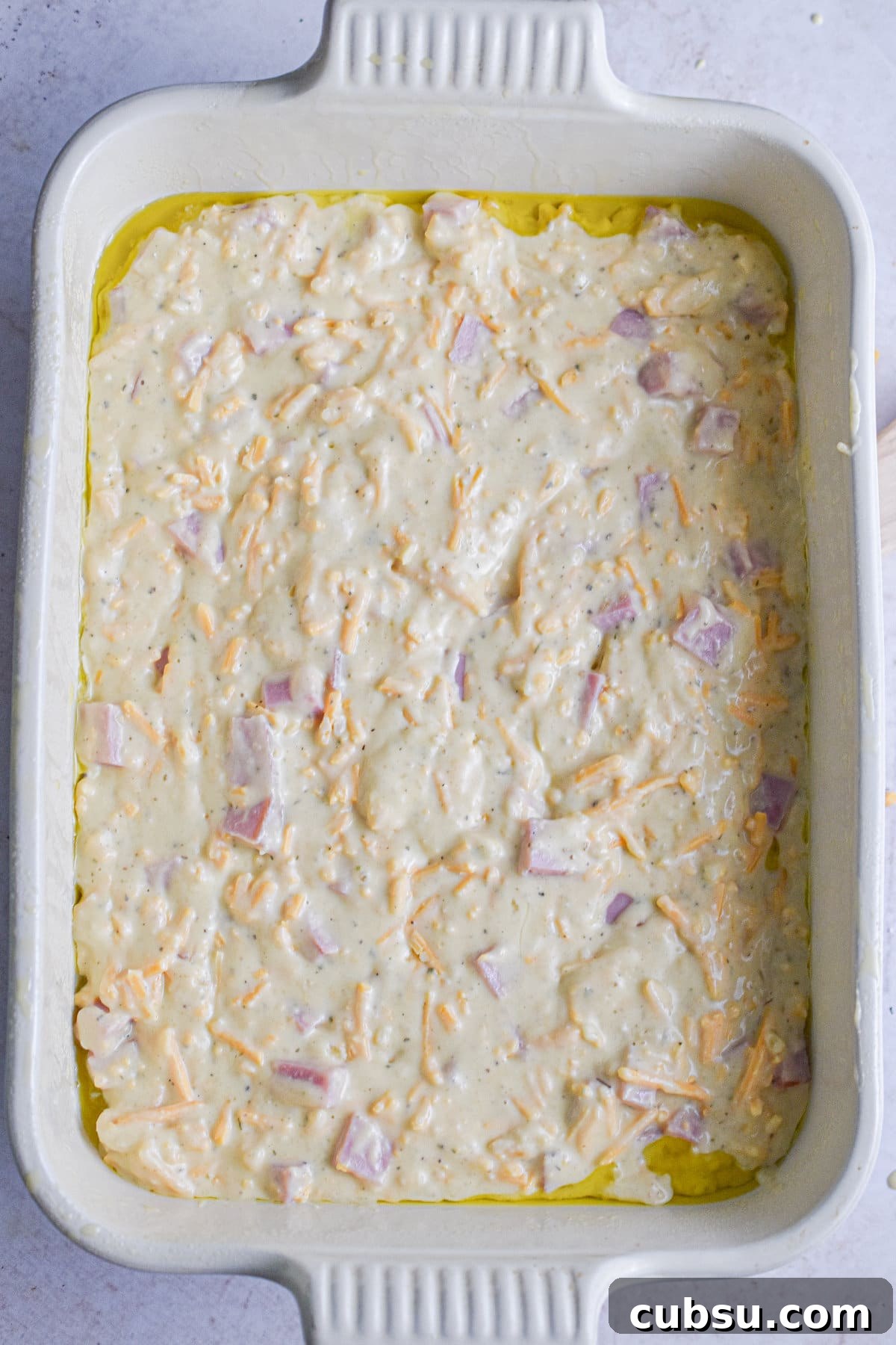 The batter is added to a baking dish.