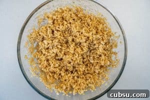 5-Ingredient Rice Krispie Treats Made Without Marshmallows 10 Mixing the rice krispies with the syrup