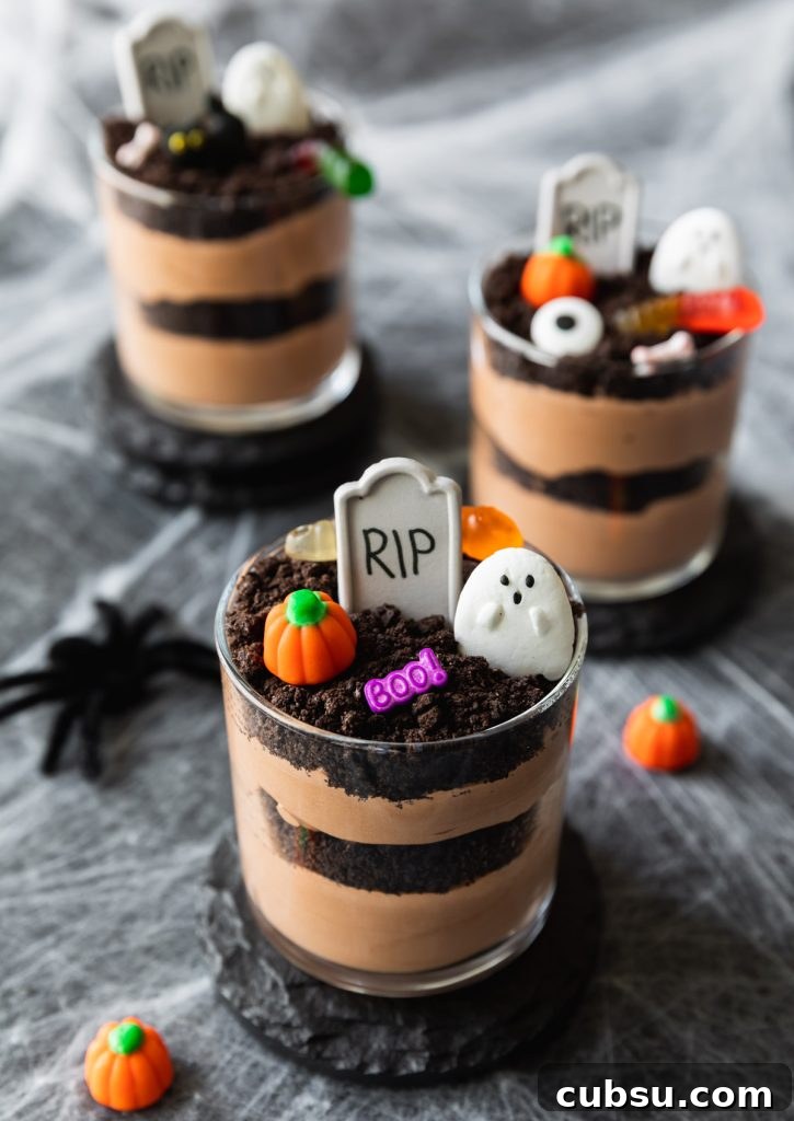 Spooky Halloween Dirt Cups Recipe for Kids and Parties 2 layers of chocolate pudding and oreo cookies, topped with Halloween candy