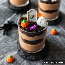 Spooky Halloween Dirt Cups Recipe for Kids and Parties 6 chocolate pudding layered with oreo cookies decorated into graveyard cups with tombstones