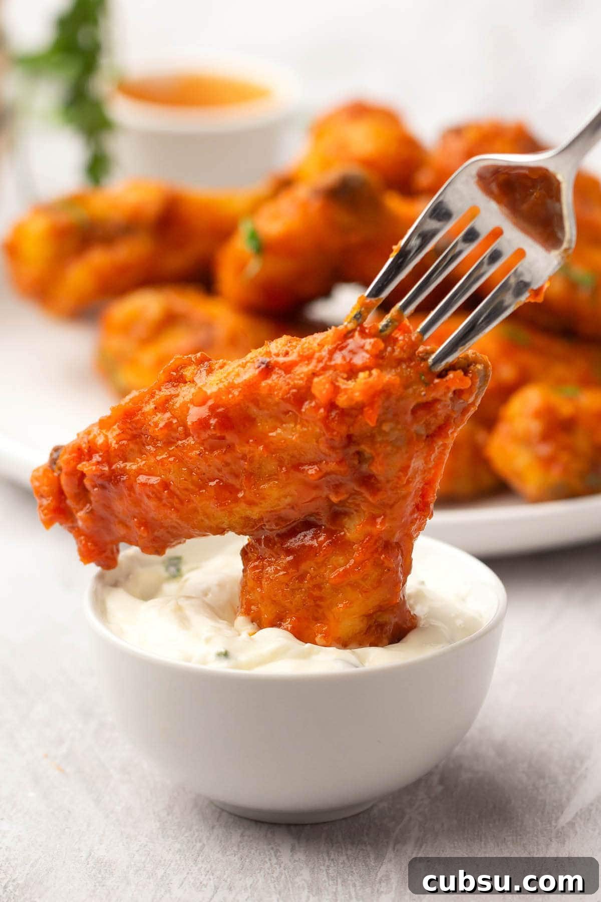 Crispy Buffalo Chicken Wings in the Air Fryer (Quick Recipe) 12 Air Fryer Buffalo Chicken Wing dipped in sauce